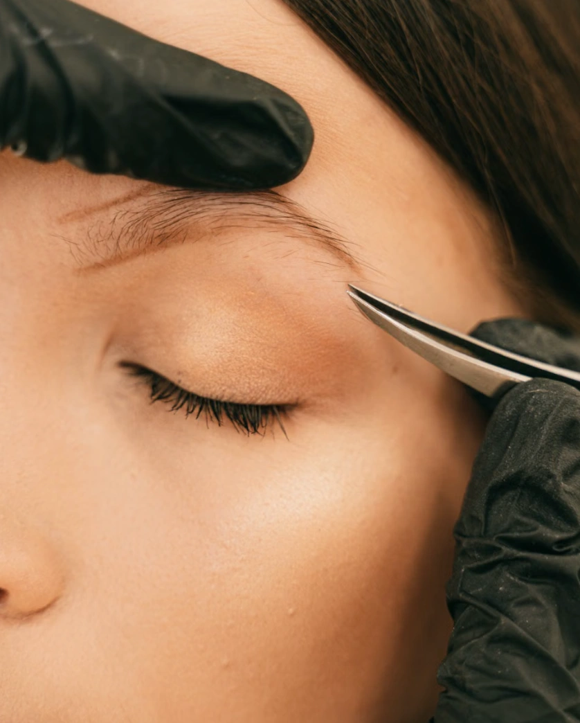 Brow tint being applied after shaping at the Erothots salon