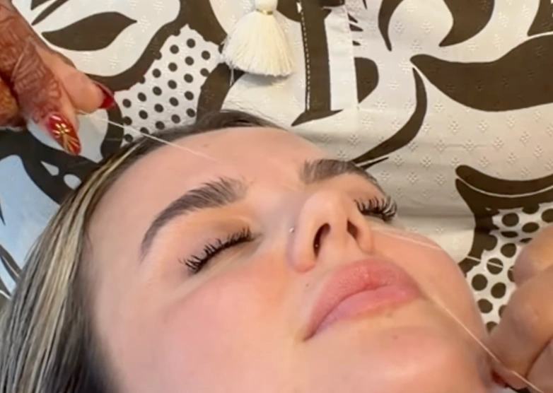 Eyebrow threading being carried out at the Erothots salon