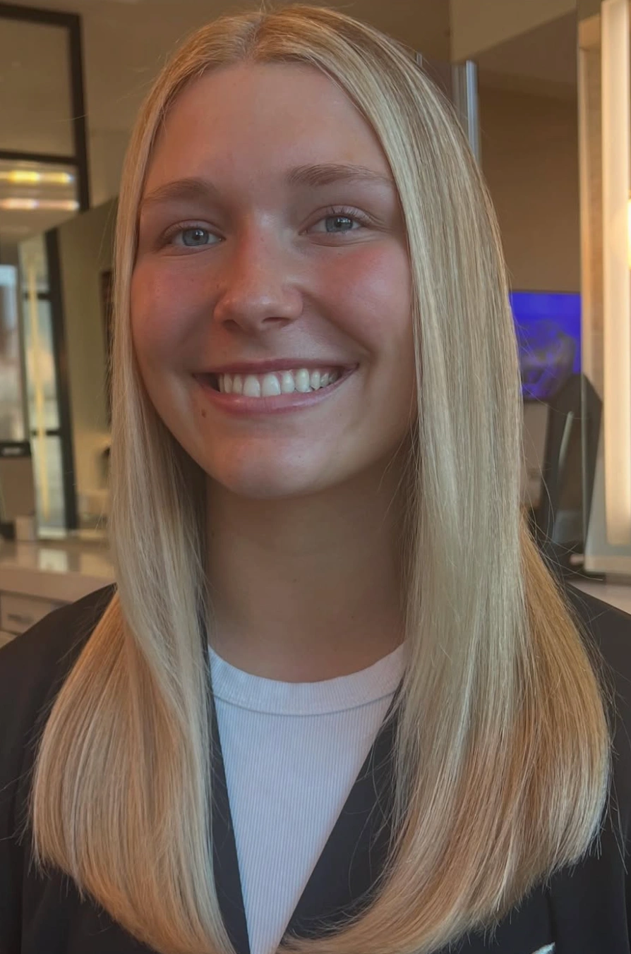 Keratin product being applied to sectioned hair before sealing