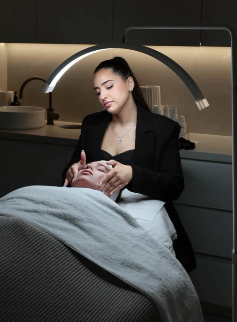Skin being analysed under a magnifying lamp before a facial at Erothots
